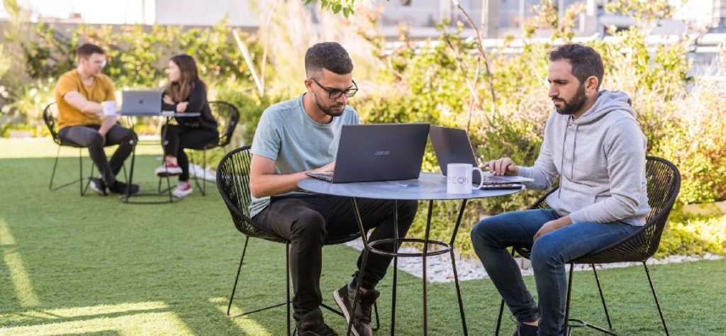 A team of engineers performing nearshore software development services on the central offices of Latin America