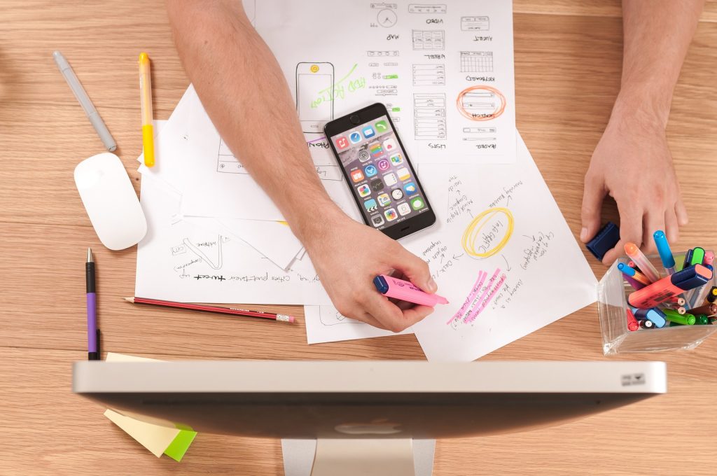 A business stakeholder outlines his plans on a desk of what he expects of the nearshore software development services