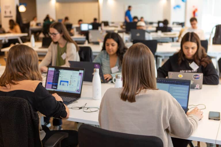 Data engineers and data scientists from latam working at the office.